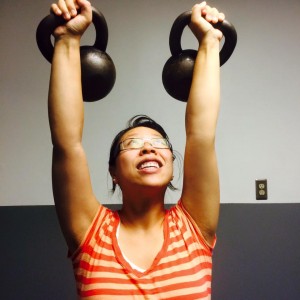 picture of Cherry pressing 2 kettlebells overhead at Eric Moss Fitness, personal training in Parsippany