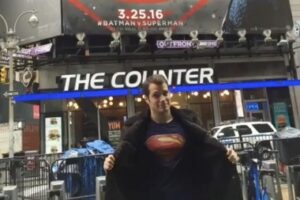 Henry Cavill as superman under superman billboard